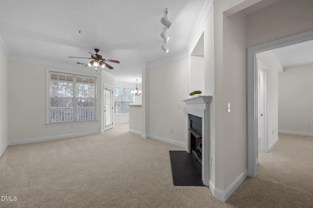 an empty room with a window and a fan
