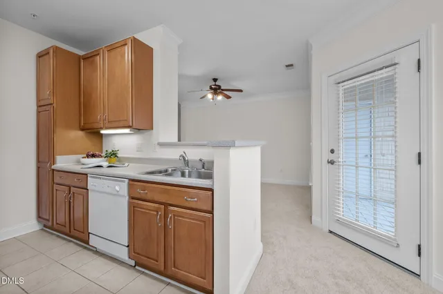 an empty room with fan and windows