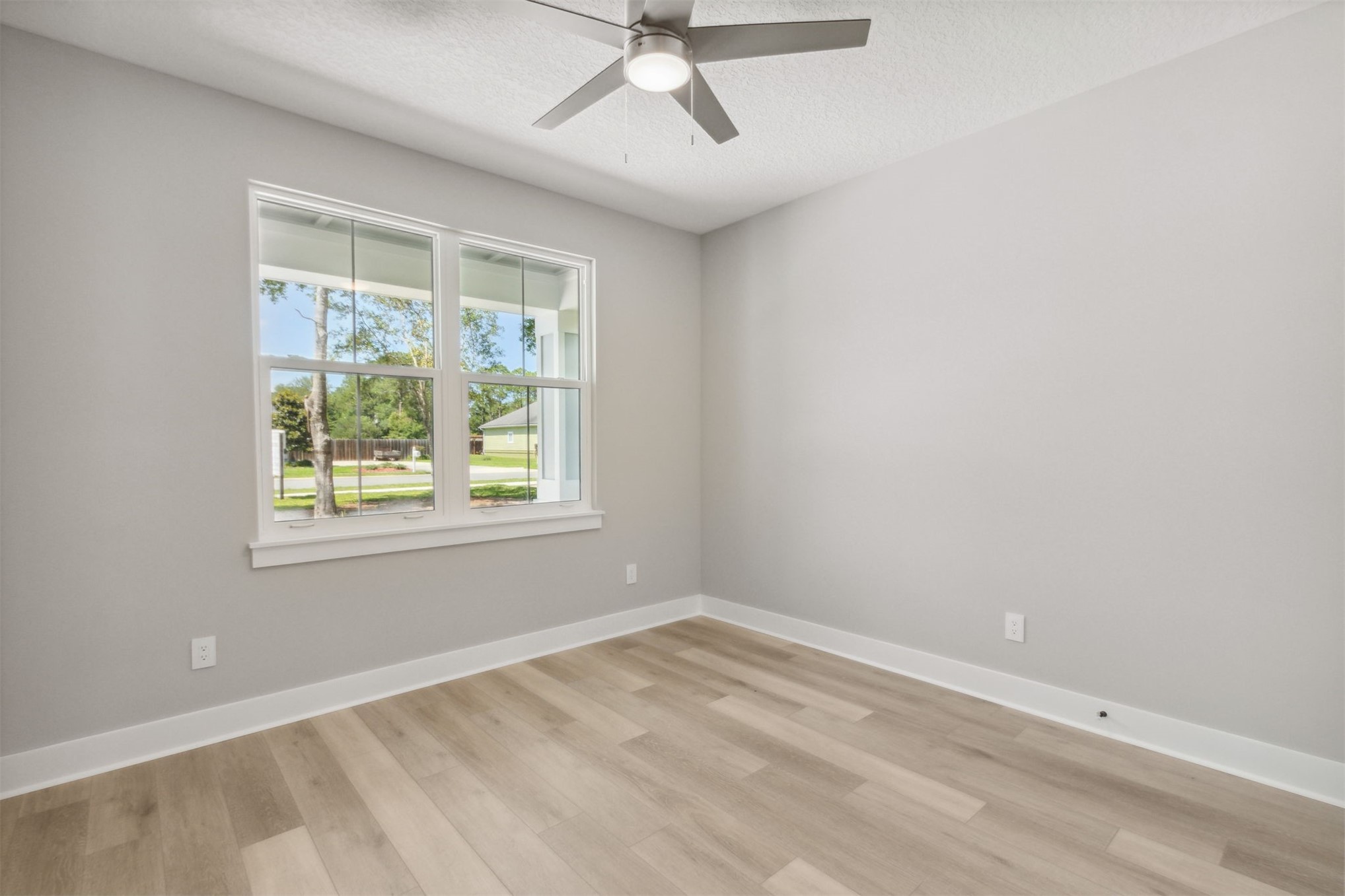 96050 Captains Pointe Road Yulee, FL 32097 - Photo 25 of 36 an empty room with a window and a fan