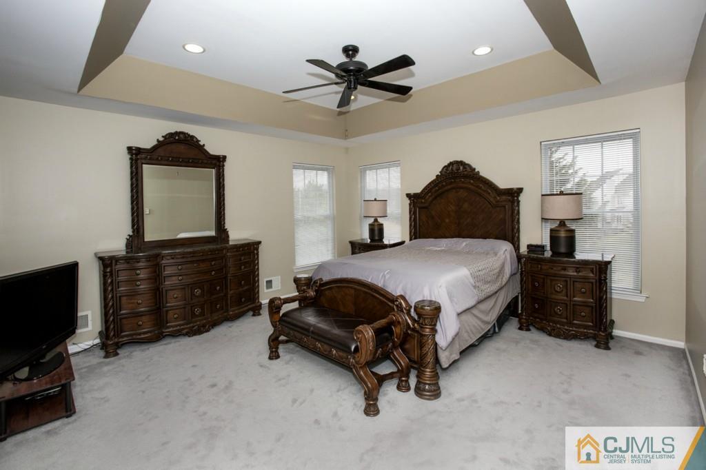 27 Timber Ridge Road North Brunswick, NJ 08902 - Photo 12 of 25 a bedroom with a bed dresser and a flat tv screen