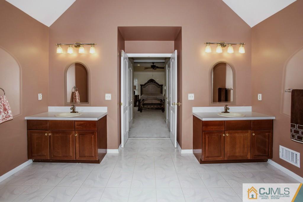27 Timber Ridge Road North Brunswick, NJ 08902 - Photo 14 of 25 a bathroom with a double vanity sink and a mirror