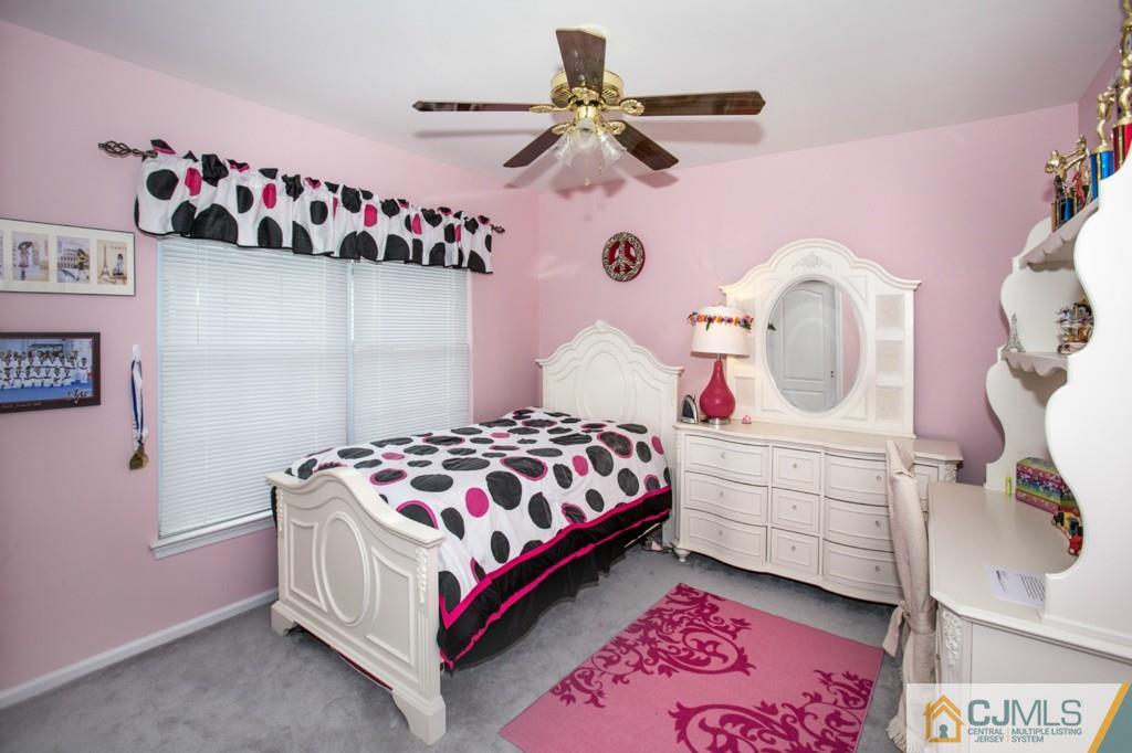 27 Timber Ridge Road North Brunswick, NJ 08902 - Photo 17 of 25 a bedroom with a bed and a dresser in it