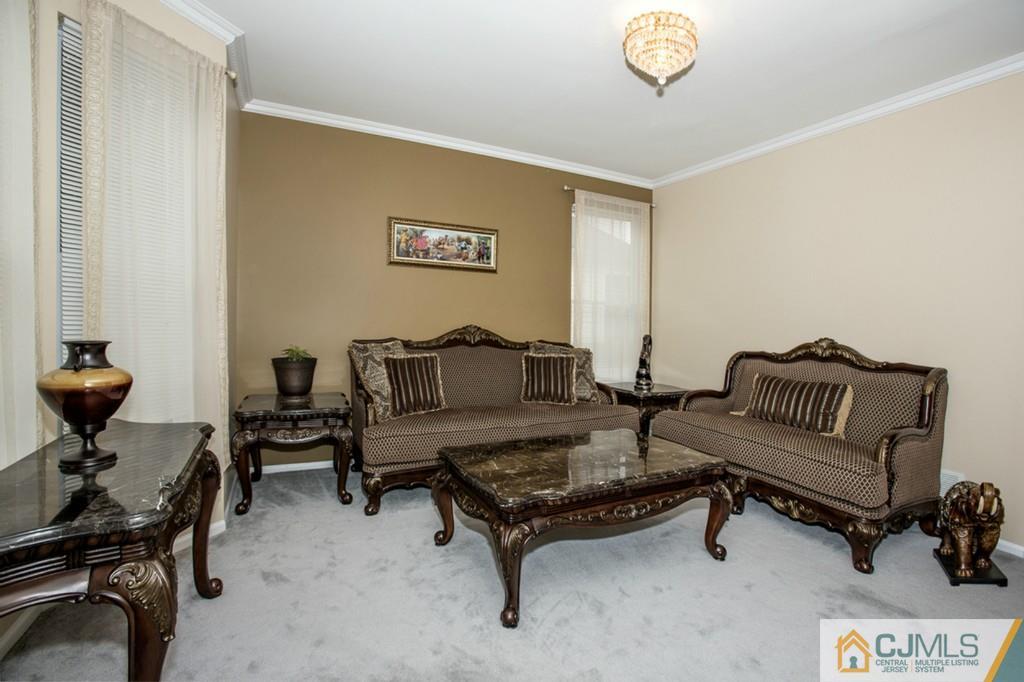 27 Timber Ridge Road North Brunswick, NJ 08902 - Photo 3 of 25 a living room with furniture and a chair
