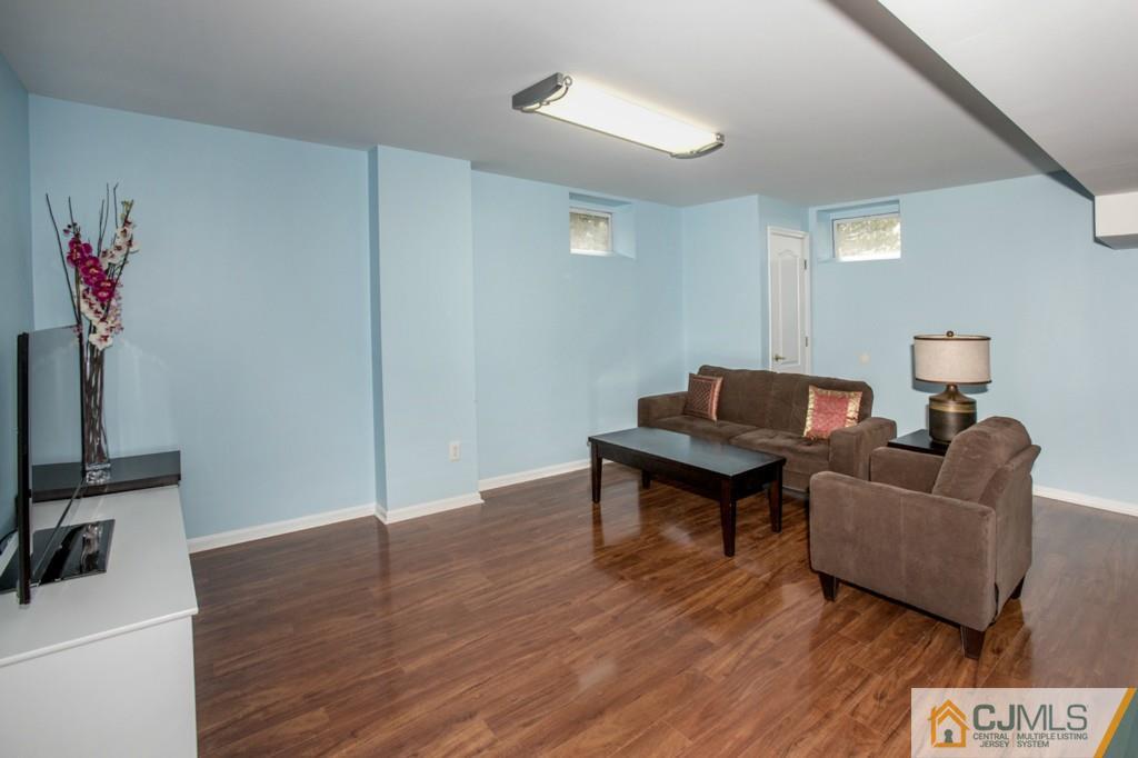 27 Timber Ridge Road North Brunswick, NJ 08902 - Photo 22 of 25 a living room with furniture and a flat screen tv