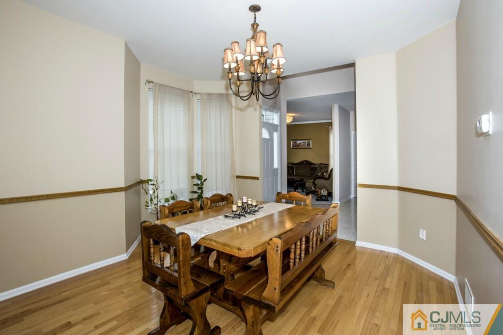 27 Timber Ridge Road North Brunswick, NJ 08902 - Photo 4 of 25 a dining room with a table and chairs