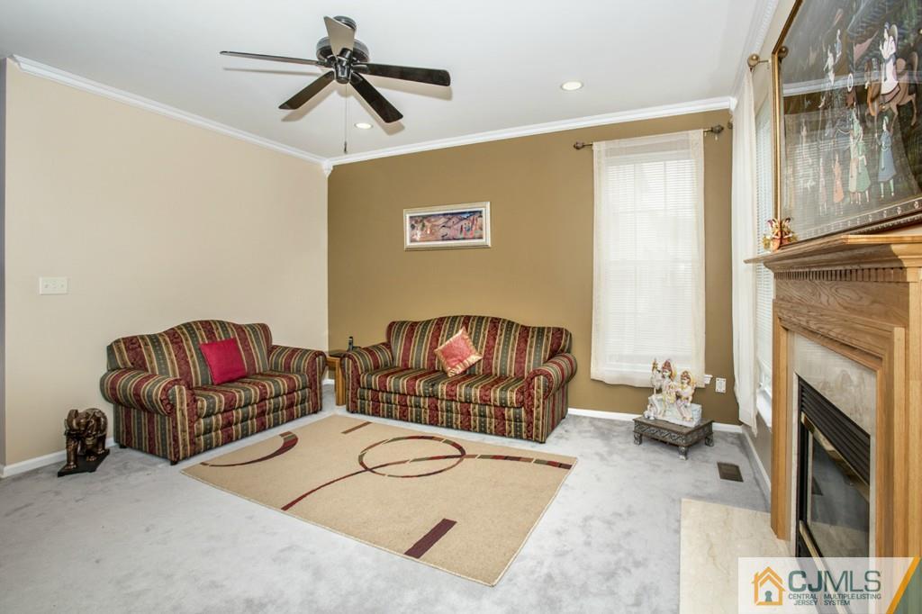 27 Timber Ridge Road North Brunswick, NJ 08902 - Photo 6 of 25 a living room with furniture a rug and a fireplace