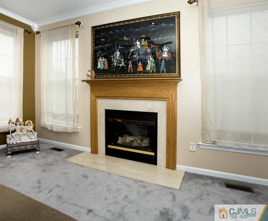 27 Timber Ridge Road North Brunswick, NJ 08902 - Photo 7 of 25 a living room with furniture and a fireplace