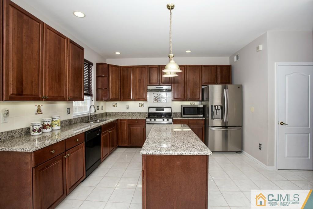 27 Timber Ridge Road North Brunswick, NJ 08902 - Photo 10 of 25 a large kitchen with stainless steel appliances granite countertop a stove refrigerator a sink and dishwasher