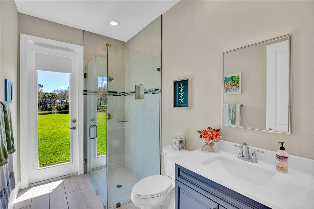 105 Night Hawk Way Sebastian, FL 32958 - Photo 23 of 36 a bathroom with a sink vanity mirror and toilet