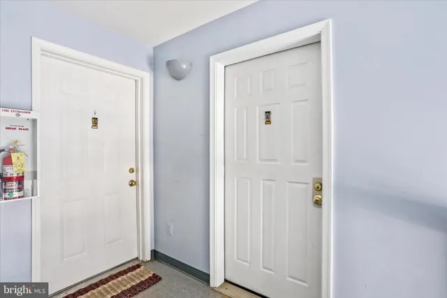 a front view of a building with snow on the road