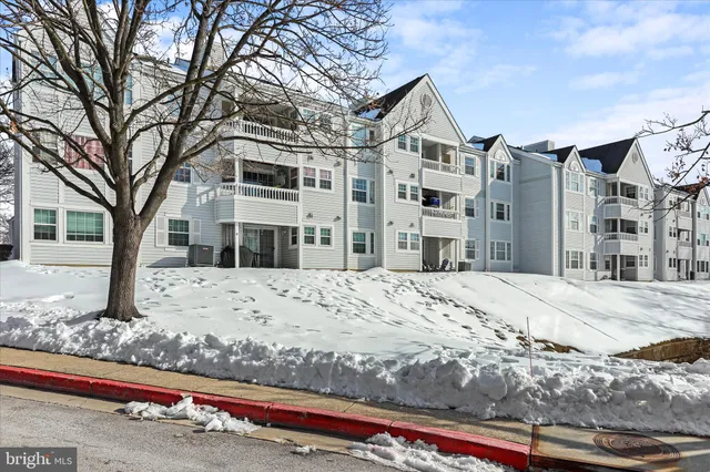 a view of a house with a yard covered in snow