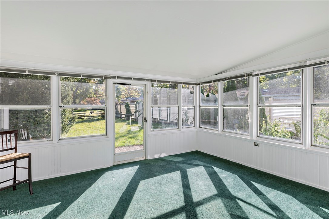 1691 Harwich Road Lyndhurst, OH 44124 - Photo 33 of 45 Enclosed porch featuring carpet flooring and vaulted ceiling