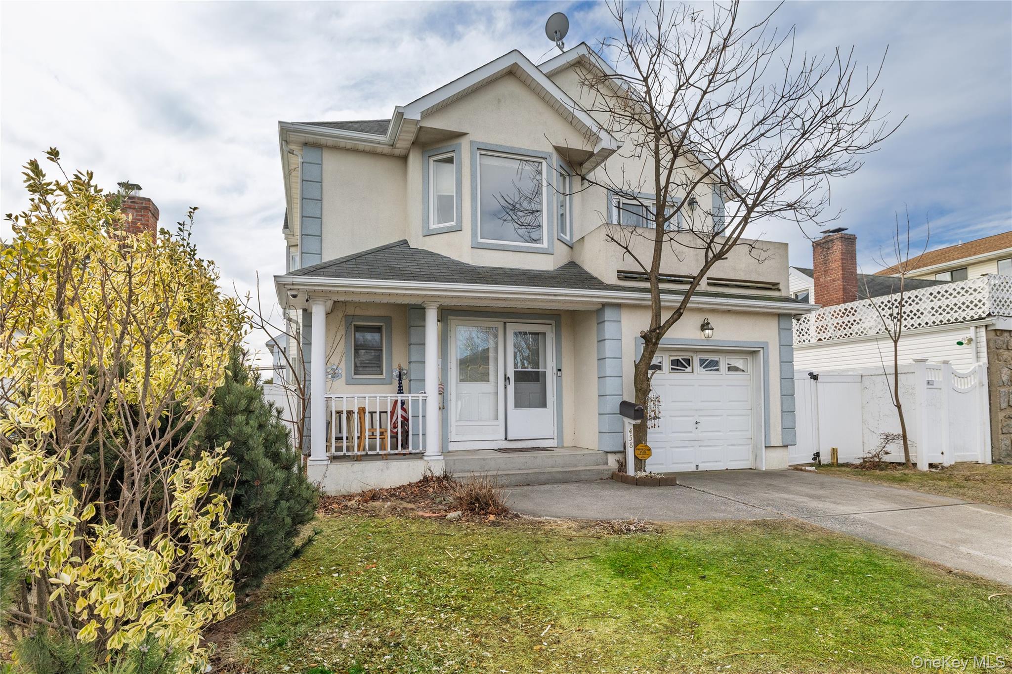 458 East Pine Street Long Beach, NY 11561 - Photo 23 of 26 a front view of a house with a garden