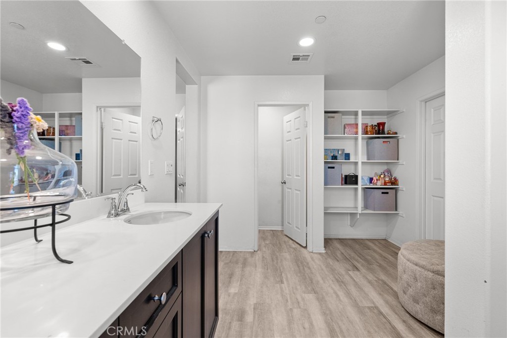 6949 Beale Road Palmdale, CA 93552 - Photo 24 of 32 a en suite bathroom with a sink double vanity and a mirror