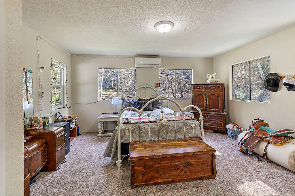 4832 Anderson Creek Road Talent, OR 97540 - Photo 26 of 39 a bedroom with furniture and a gym machine