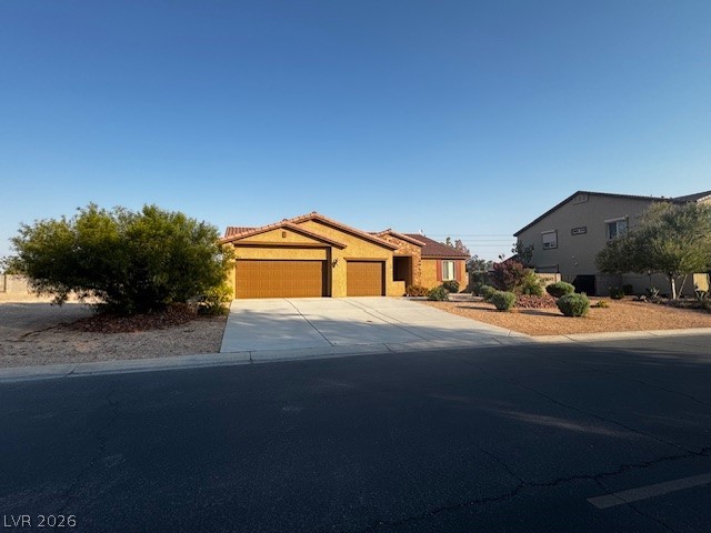 3744 River Heights Lane Logandale, NV 89021 - Photo 2 of 17 A well-maintained driveway leads to a welcoming home with manicured landscaping.