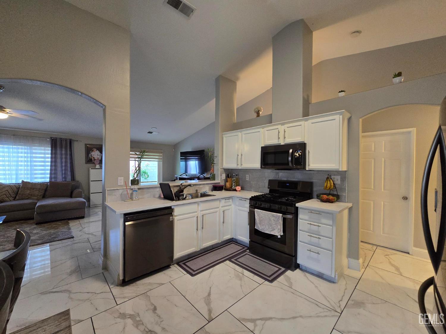 Undisclosed Address Bakersfield, CA 93307 - Photo 3 of 19 a kitchen with stainless steel appliances granite countertop a stove top oven a sink a counter top space and cabinets