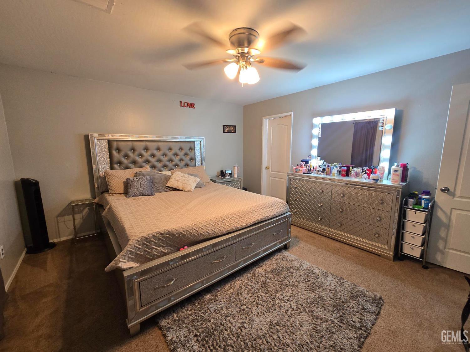 Undisclosed Address Bakersfield, CA 93307 - Photo 7 of 19 a bedroom with a bed and a chandelier