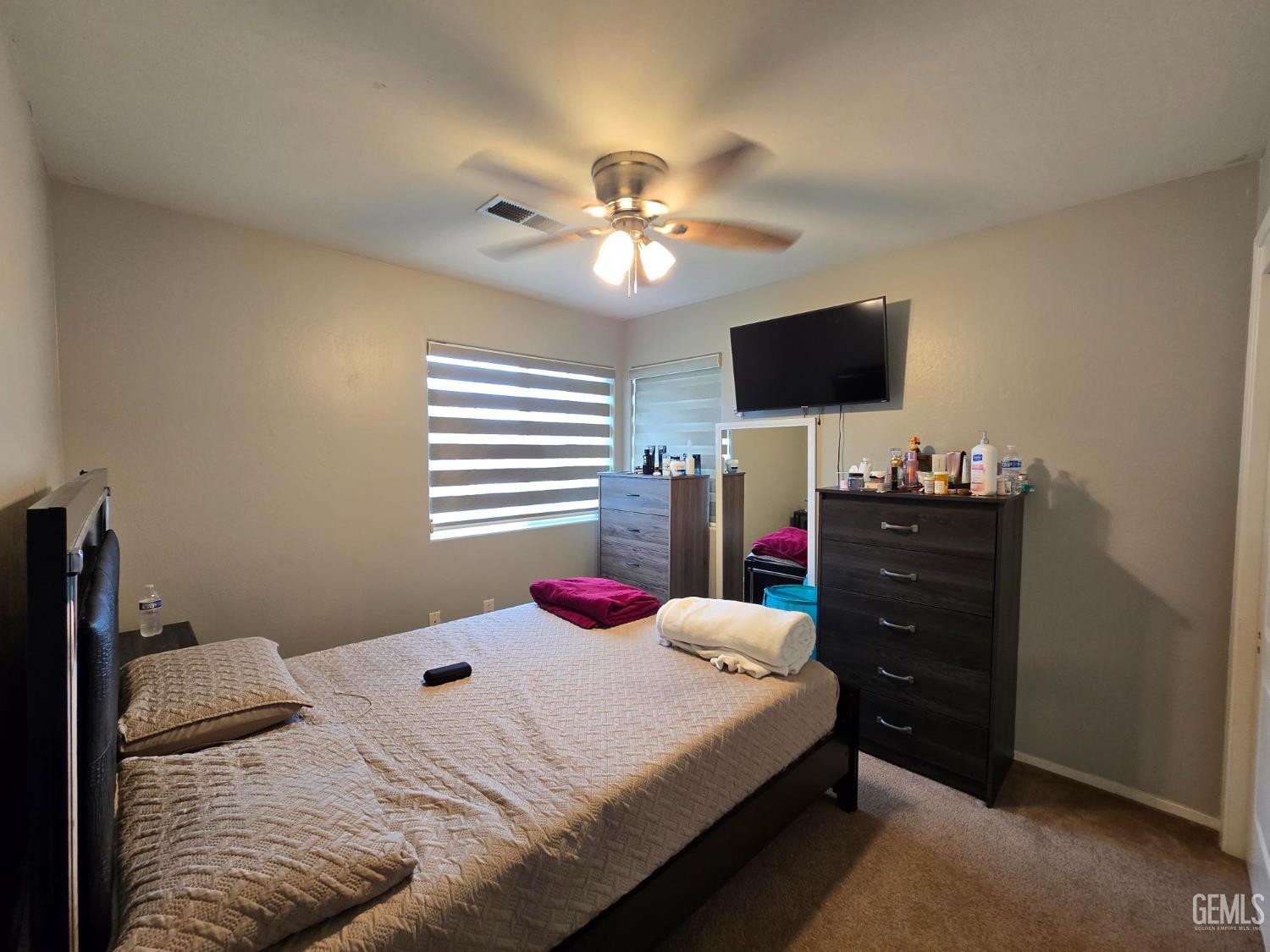 Undisclosed Address Bakersfield, CA 93307 - Photo 8 of 19 a bedroom with a bed and a flat screen tv