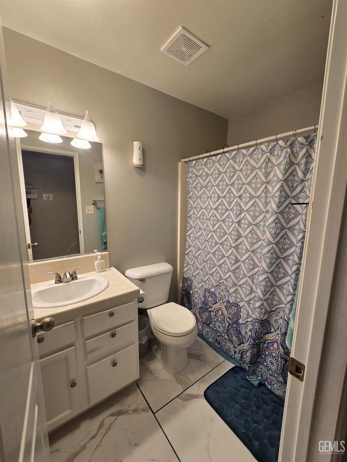 Undisclosed Address Bakersfield, CA 93307 - Photo 10 of 19 a bathroom with a double vanity sink mirror and toilet