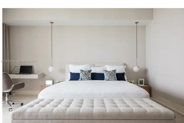 a bedroom with a bed lamp and window