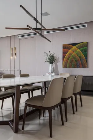 a kitchen with kitchen island granite countertop a sink and a refrigerator
