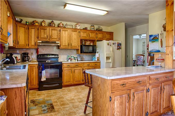 951 Copella Road Bath, PA 18014 - Photo 3 of 25 a kitchen with stainless steel appliances granite countertop a refrigerator a stove top oven a sink and dishwasher