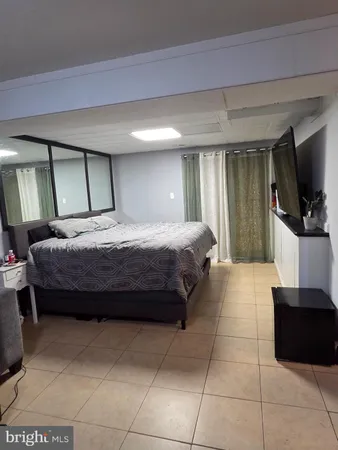 a bedroom with a bed and a television