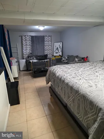 a bedroom with a bed and glass door