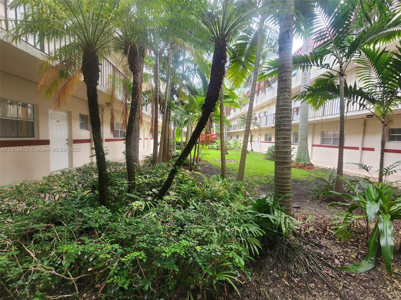 8600 Southwest 67th Avenue, Unit 906 Pinecrest, FL 33156 - Photo 1 of 27 a backyard of a house with lots of green space