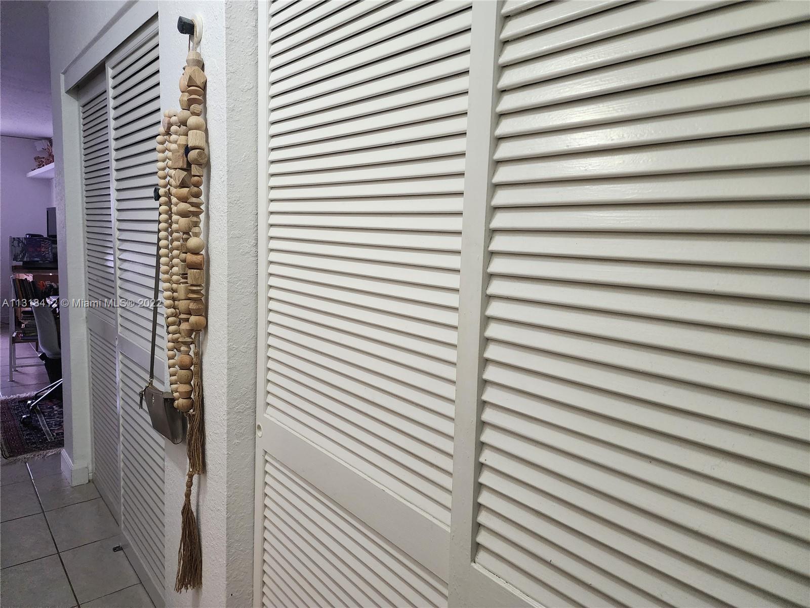 8600 Southwest 67th Avenue, Unit 906 Pinecrest, FL 33156 - Photo 11 of 27 a view of a room with a door and a wooden floor