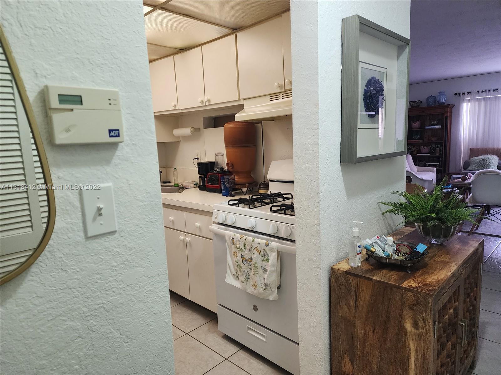 8600 Southwest 67th Avenue, Unit 906 Pinecrest, FL 33156 - Photo 12 of 27 a kitchen with stainless steel appliances granite countertop a stove a sink and a refrigerator