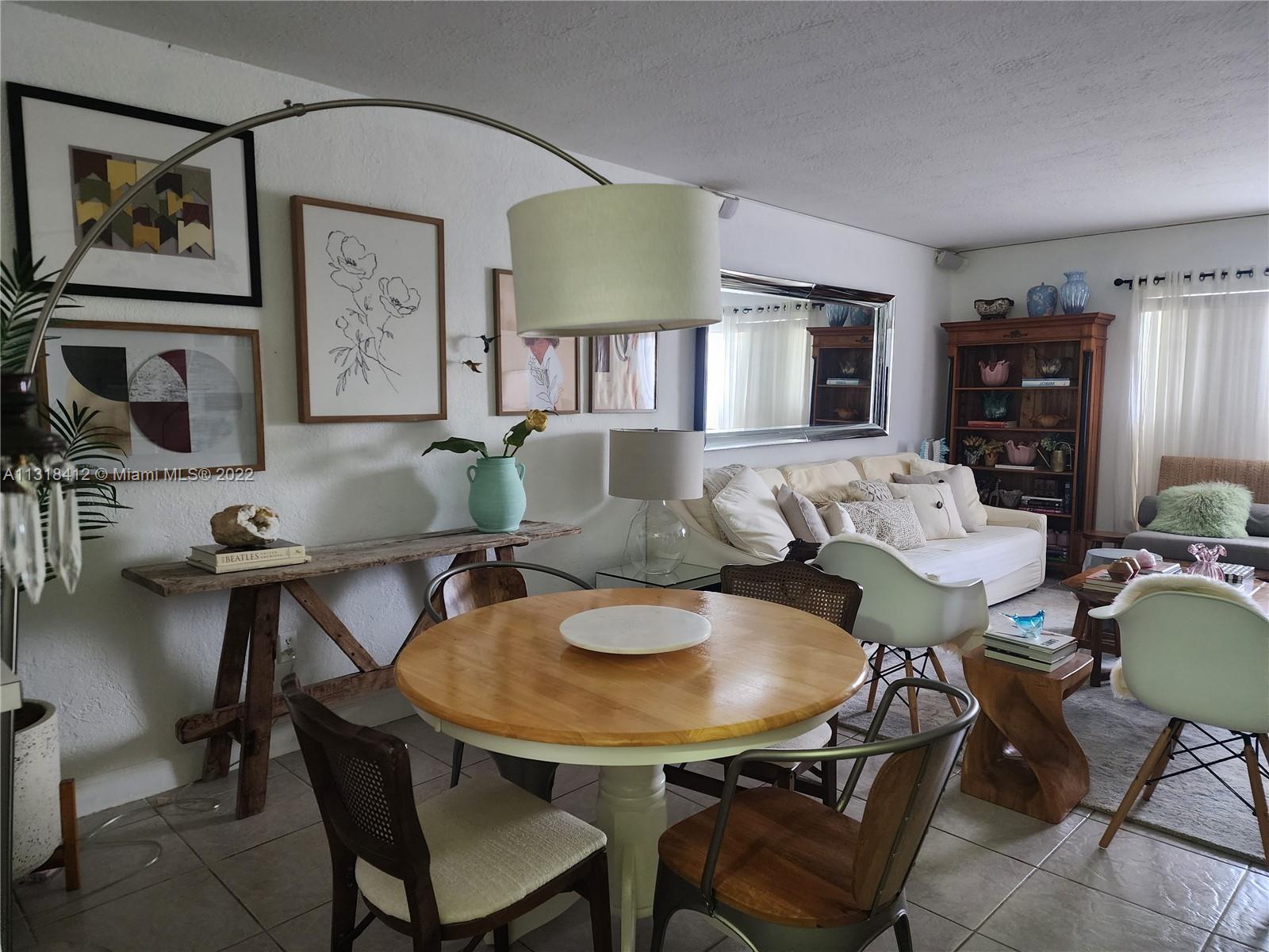 8600 Southwest 67th Avenue, Unit 906 Pinecrest, FL 33156 - Photo 13 of 27 a view of a dining room with furniture and window