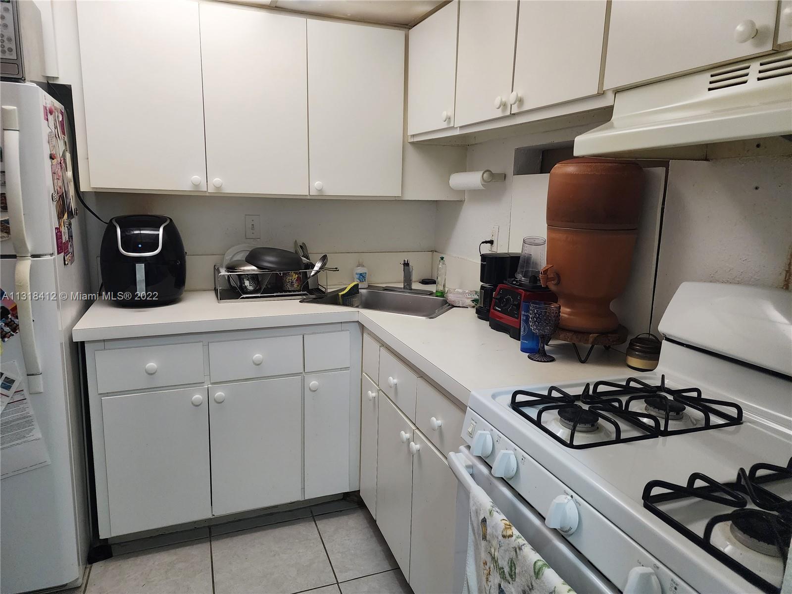8600 Southwest 67th Avenue, Unit 906 Pinecrest, FL 33156 - Photo 15 of 27 a kitchen with sink a stove and cabinets