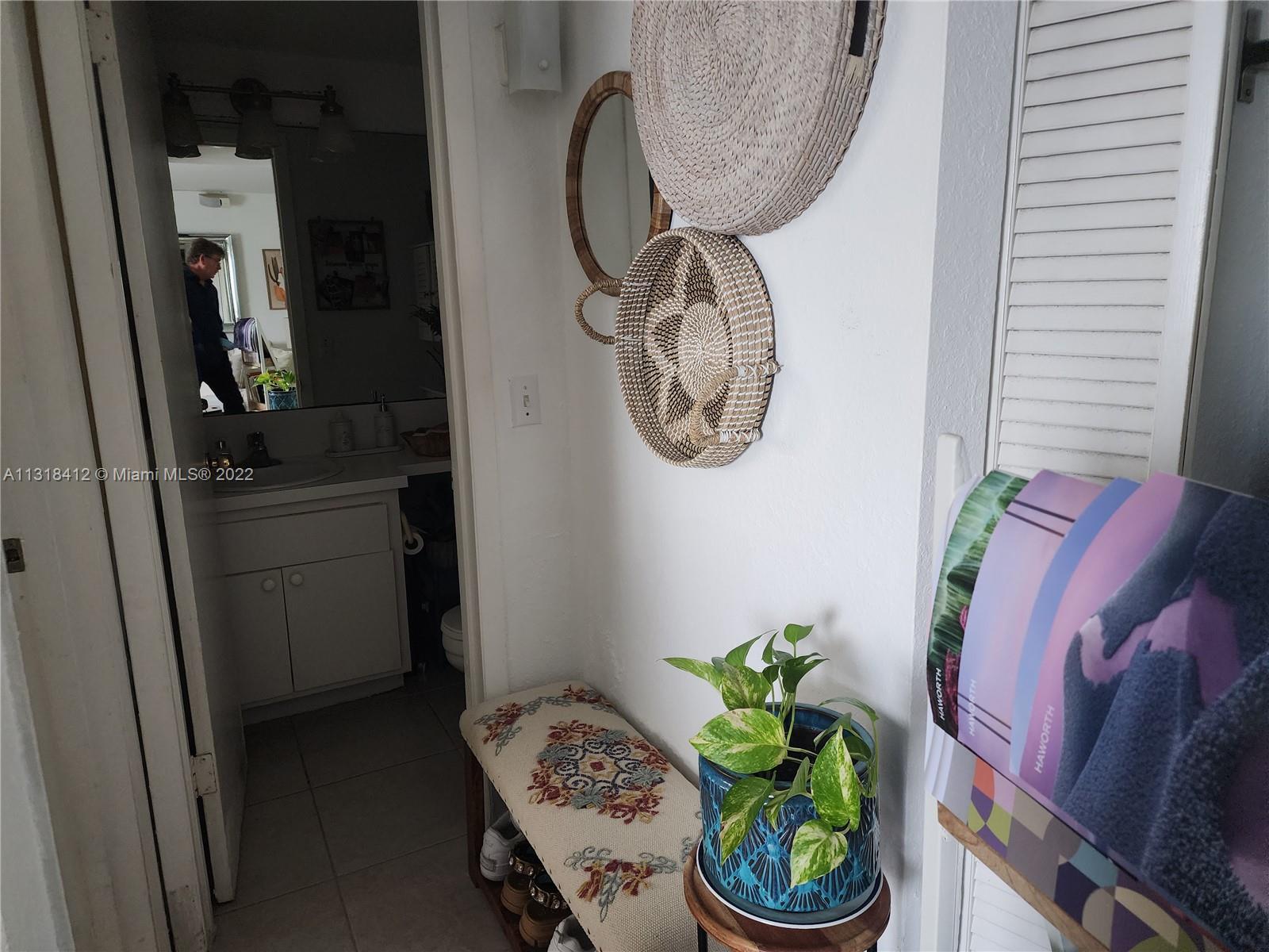 8600 Southwest 67th Avenue, Unit 906 Pinecrest, FL 33156 - Photo 19 of 27 a bathroom with a sink a toilet and a mirror