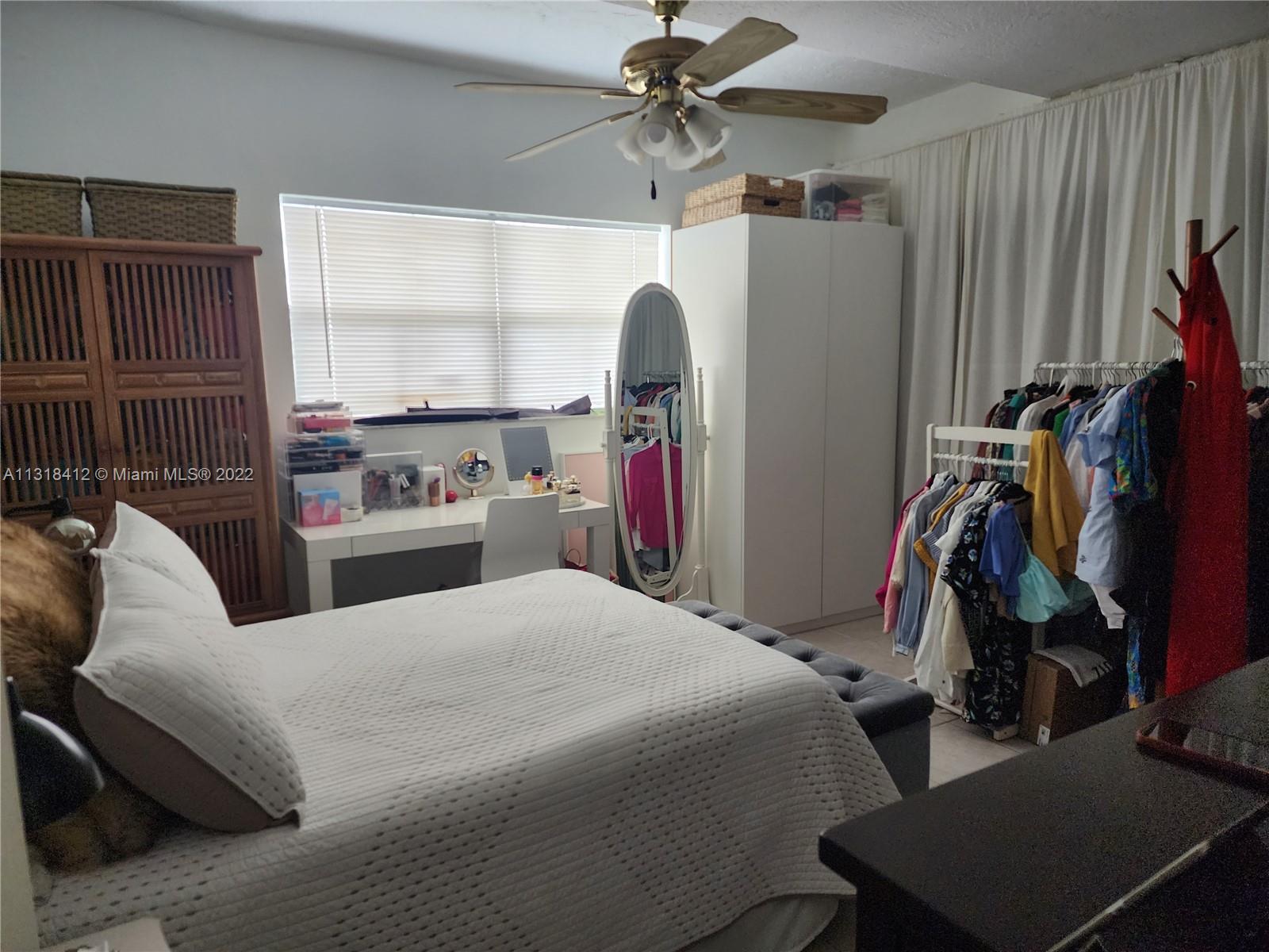 8600 Southwest 67th Avenue, Unit 906 Pinecrest, FL 33156 - Photo 21 of 27 a bedroom with a bed and a window