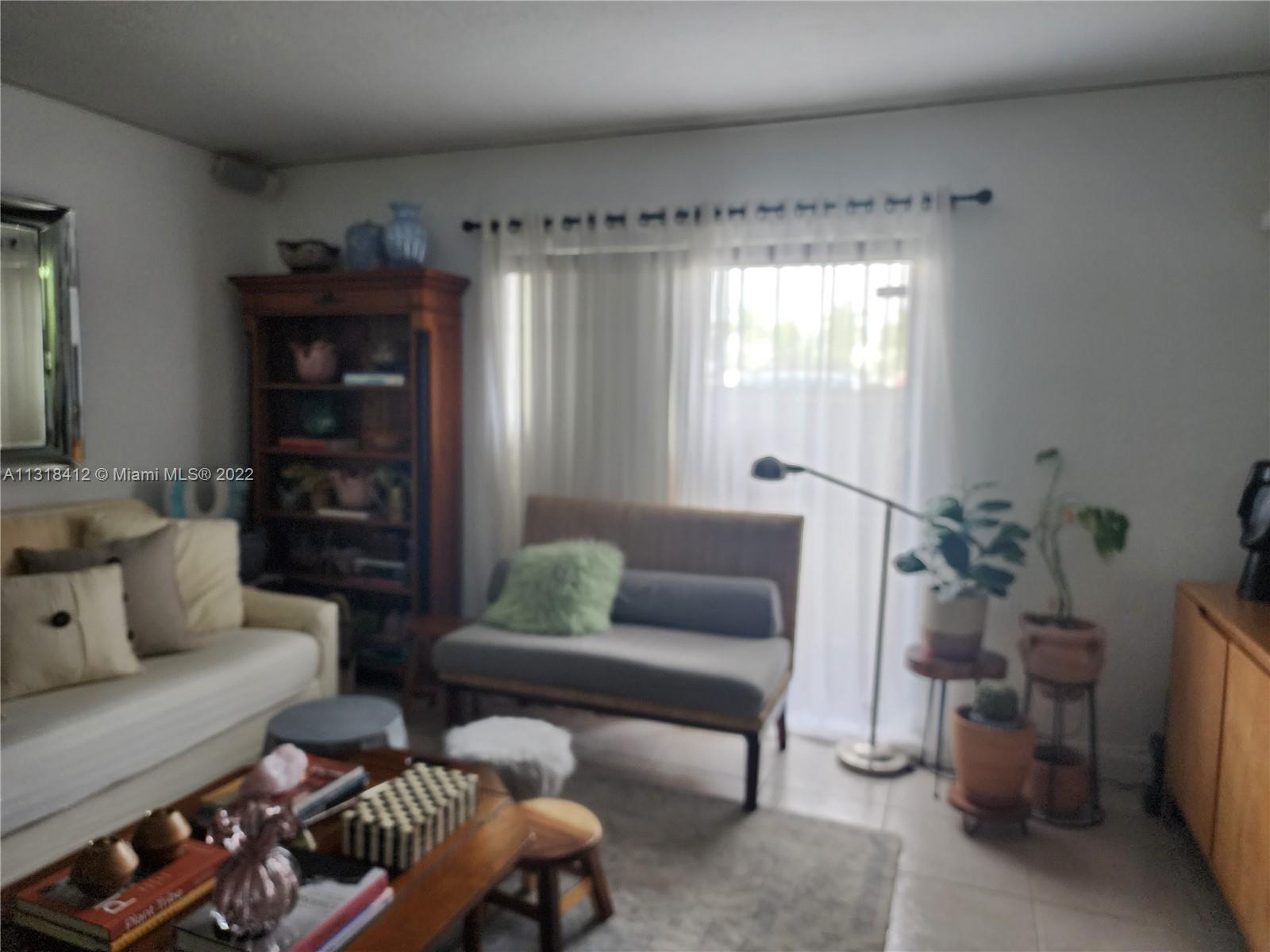 8600 Southwest 67th Avenue, Unit 906 Pinecrest, FL 33156 - Photo 7 of 27 a living room with furniture and a window