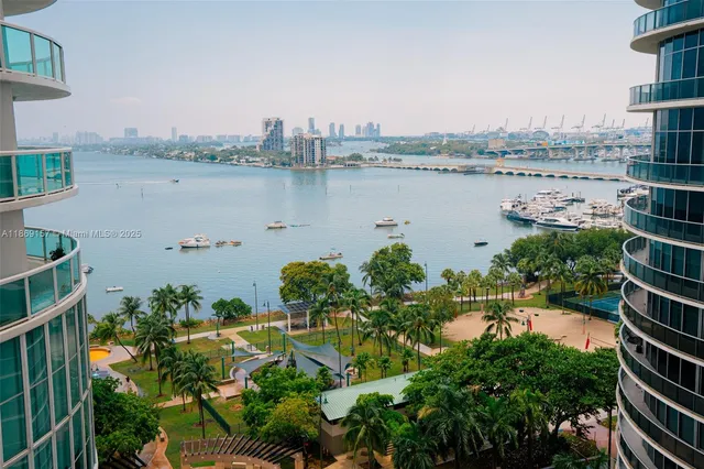 an aerial view of a house with outdoor space and lake view in back