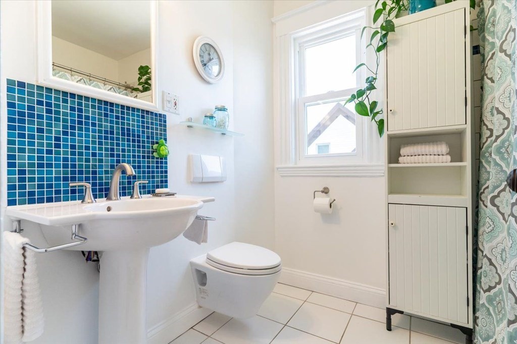 6 Malverna Road Boston, MA 02131 - Photo 11 of 29 a bathroom with a sink a toilet and shower