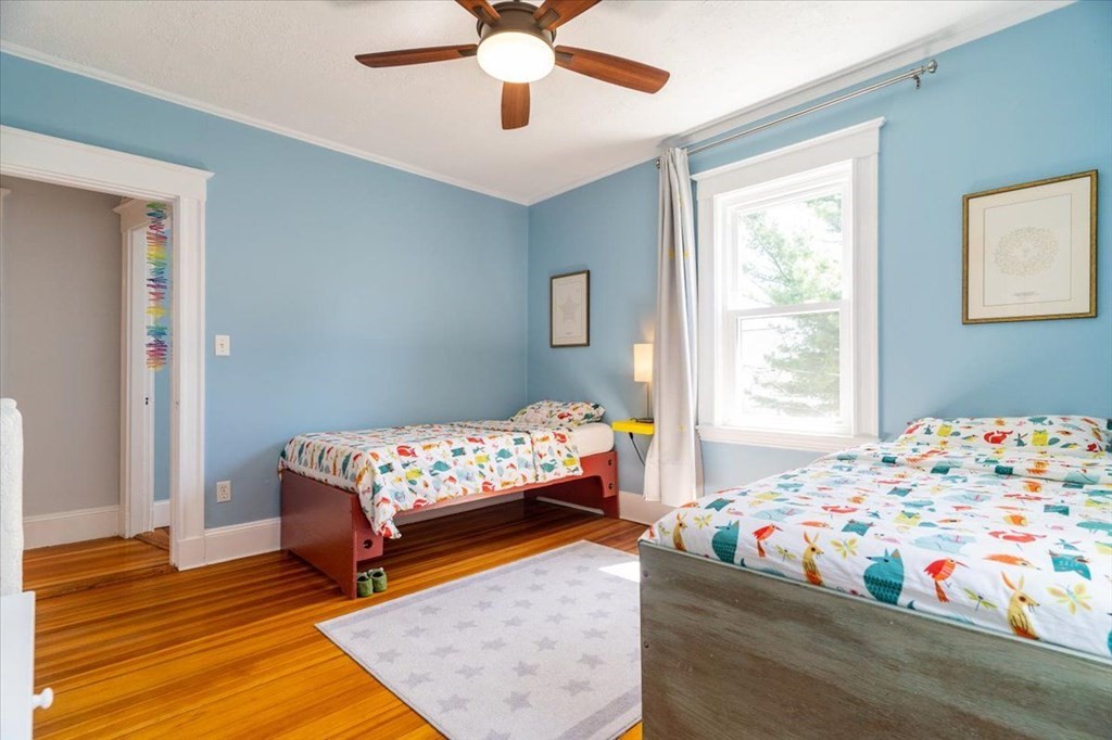 6 Malverna Road Boston, MA 02131 - Photo 14 of 29 a bedroom with two beds and a chandelier