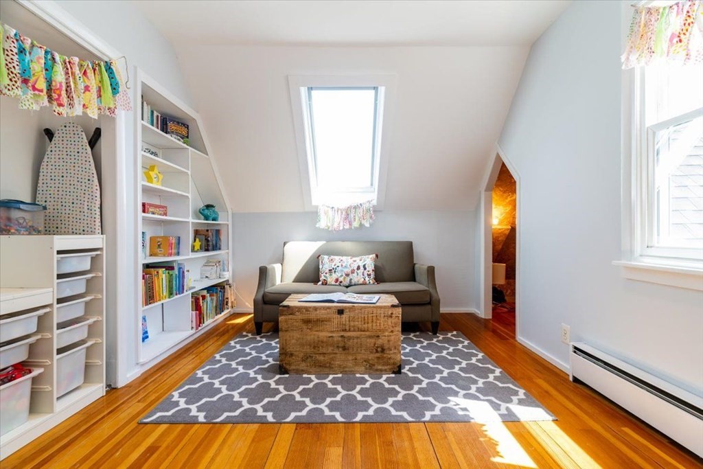 6 Malverna Road Boston, MA 02131 - Photo 20 of 29 a living room with a bed and a book shelf
