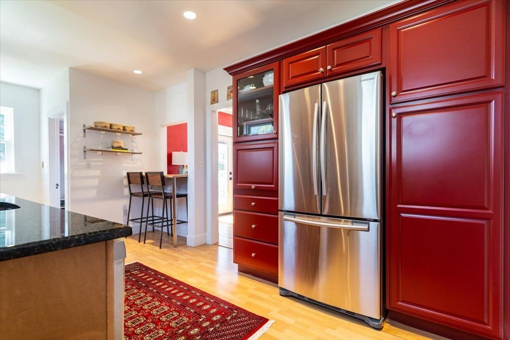 6 Malverna Road Boston, MA 02131 - Photo 3 of 29 a kitchen with stainless steel appliances granite countertop a refrigerator and a wooden cabinets