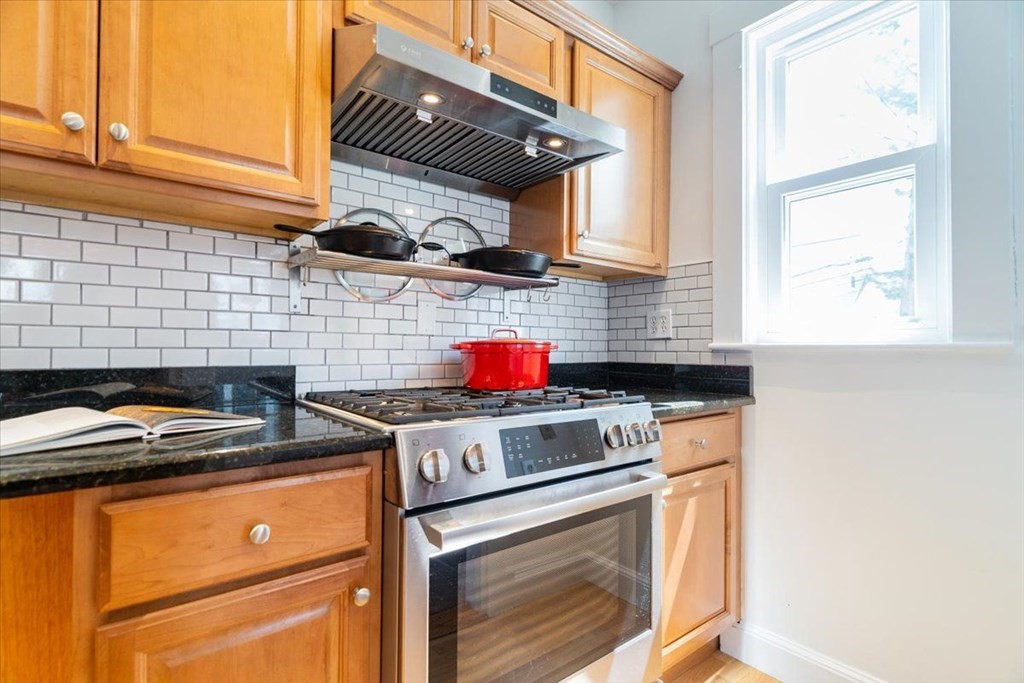 6 Malverna Road Boston, MA 02131 - Photo 4 of 29 a kitchen with stainless steel appliances granite countertop stove top oven and cabinets