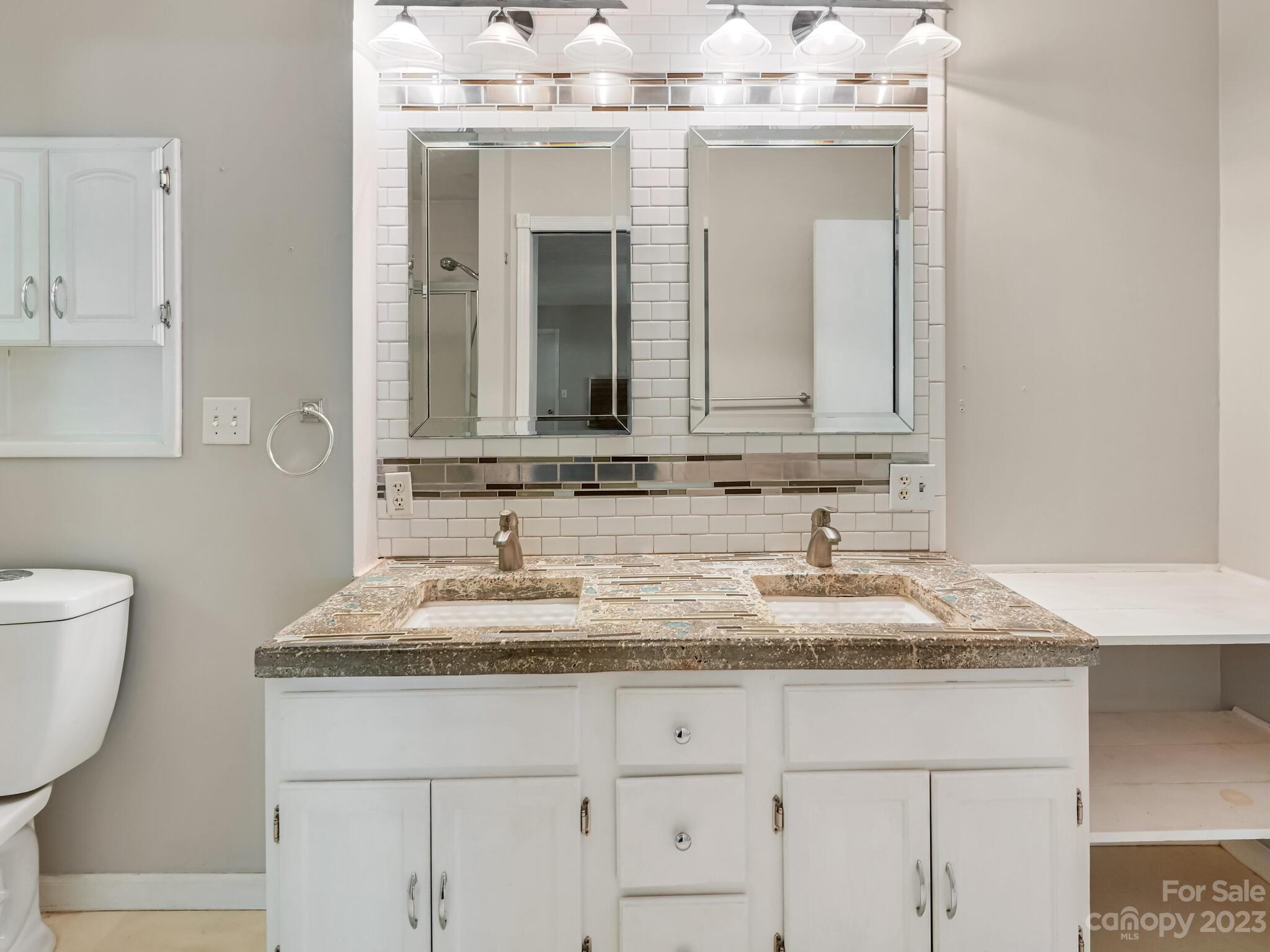 843 North Fork Road Barnardsville, NC 28709 - Photo 20 of 37 a bathroom with a granite countertop sink and a mirror