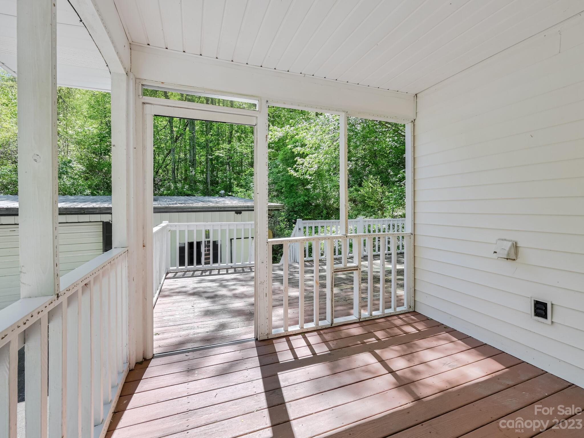 843 North Fork Road Barnardsville, NC 28709 - Photo 23 of 37 a view of a deck with wooden floor and fence with a floor to ceiling window