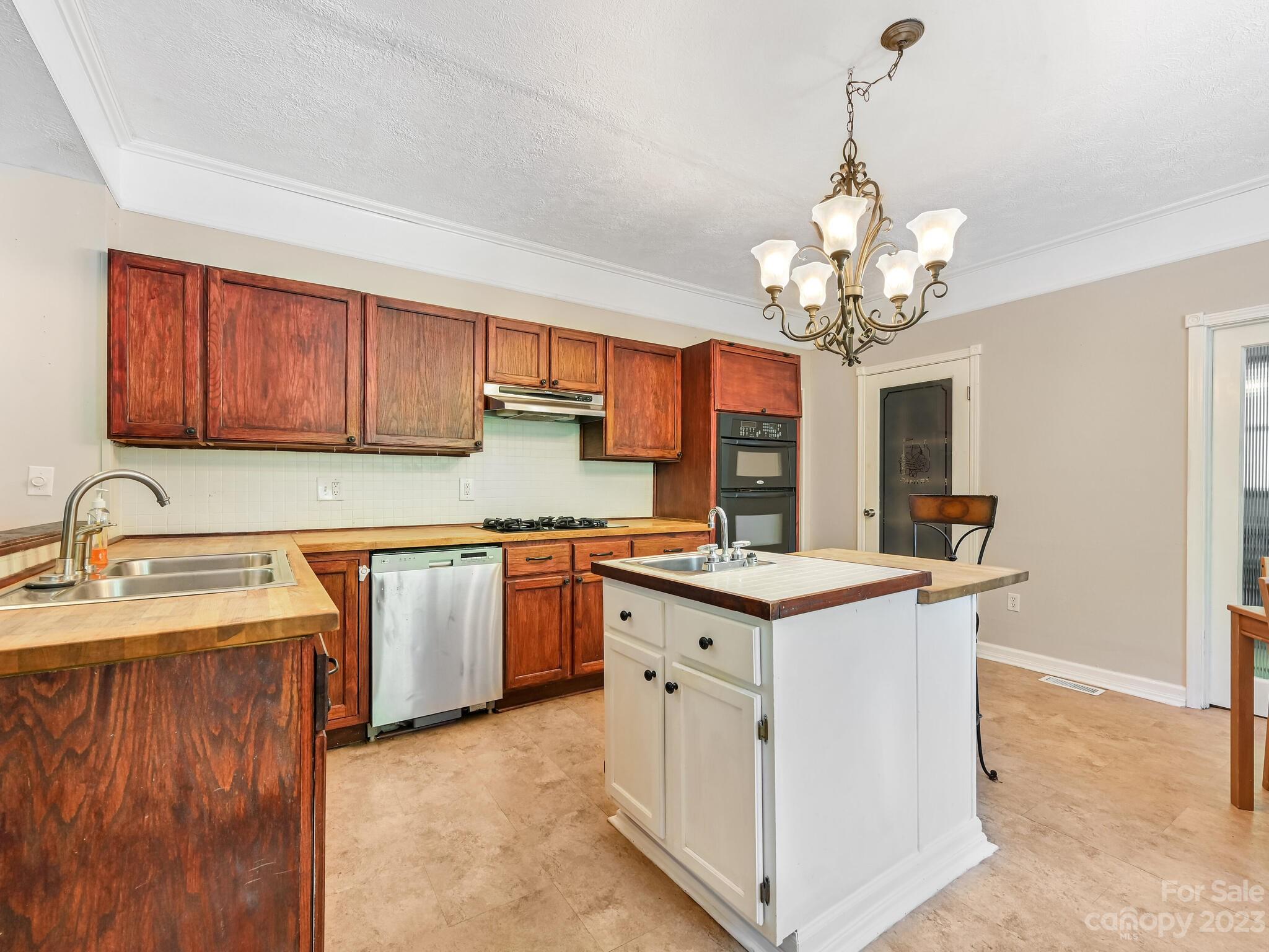 843 North Fork Road Barnardsville, NC 28709 - Photo 8 of 37 a kitchen with stainless steel appliances granite countertop a sink stove and refrigerator