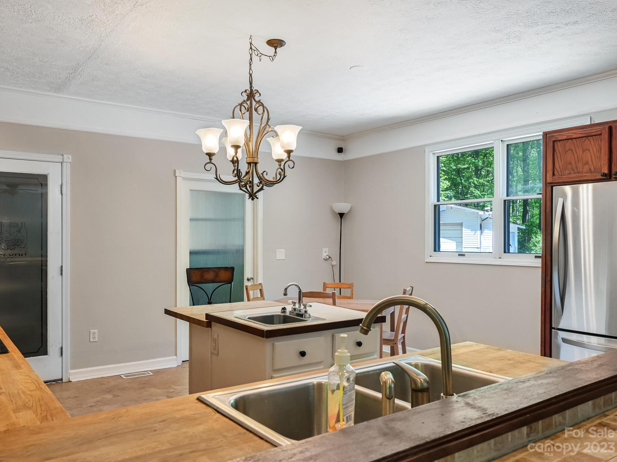 843 North Fork Road Barnardsville, NC 28709 - Photo 9 of 37 a kitchen with a refrigerator sink and wooden floor