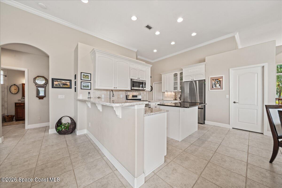1050 Starling Way Rockledge, FL 32955 - Photo 13 of 59 a view of kitchen with refrigerator and window