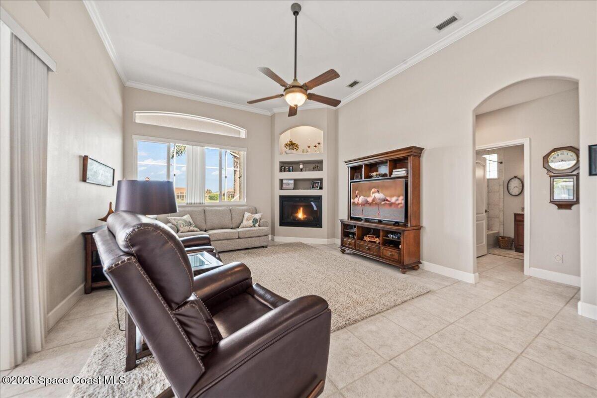 1050 Starling Way Rockledge, FL 32955 - Photo 18 of 59 a living room with furniture a fireplace and a chandelier