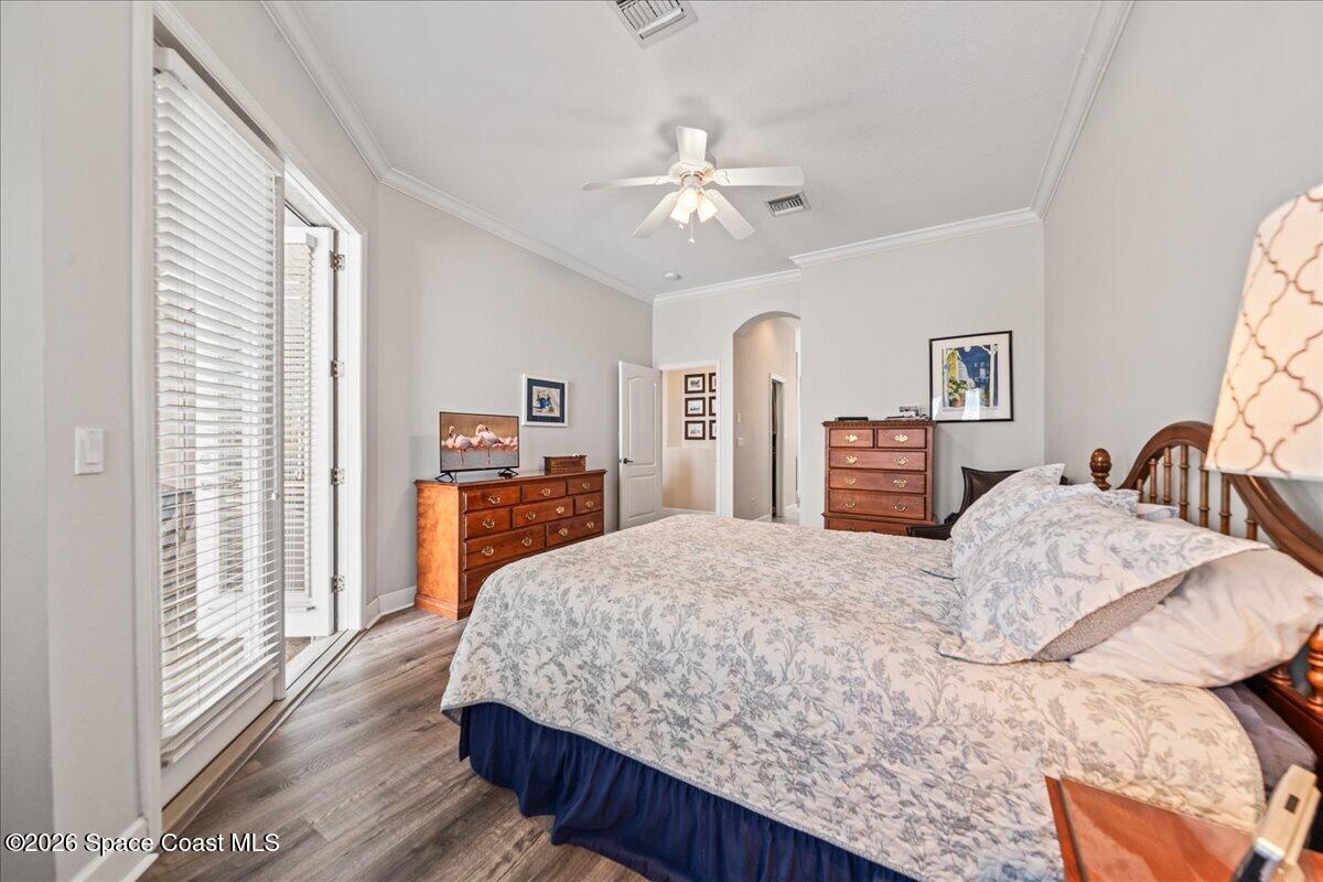 1050 Starling Way Rockledge, FL 32955 - Photo 20 of 59 a bedroom with a large bed and a chandelier